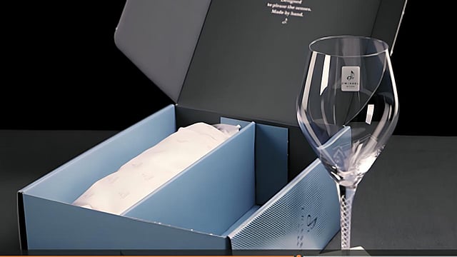 A glass is positioned near an open packaging, a result of the collaboration between Zwiesel Glas and Mondi.